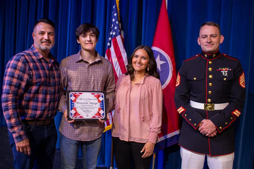 A student is honored for serving in the US Armed Forces after high school